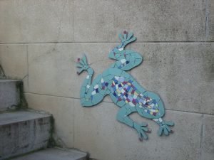 création d'une grenouille en mosaïque sur un mur extérieur de maison